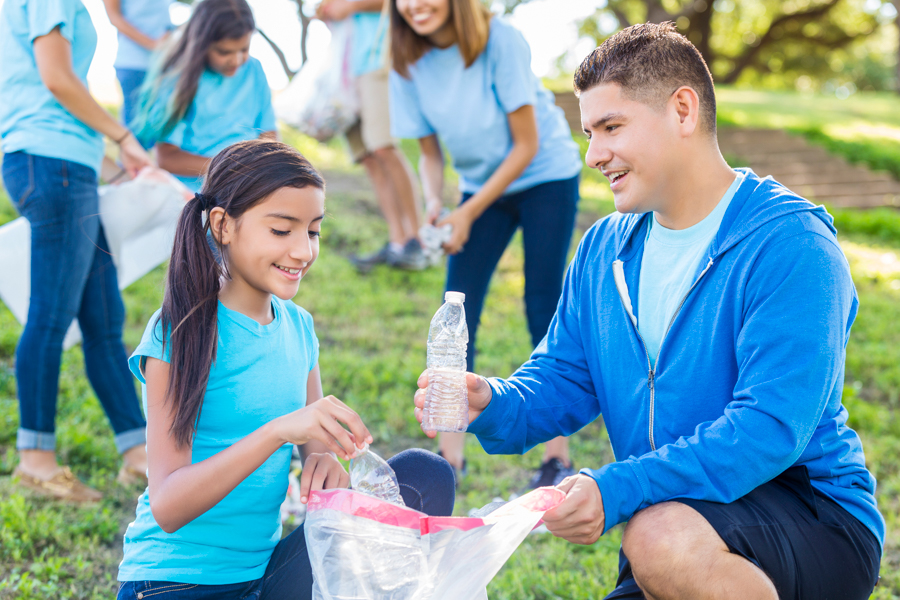 Tw young people cleaning up trash