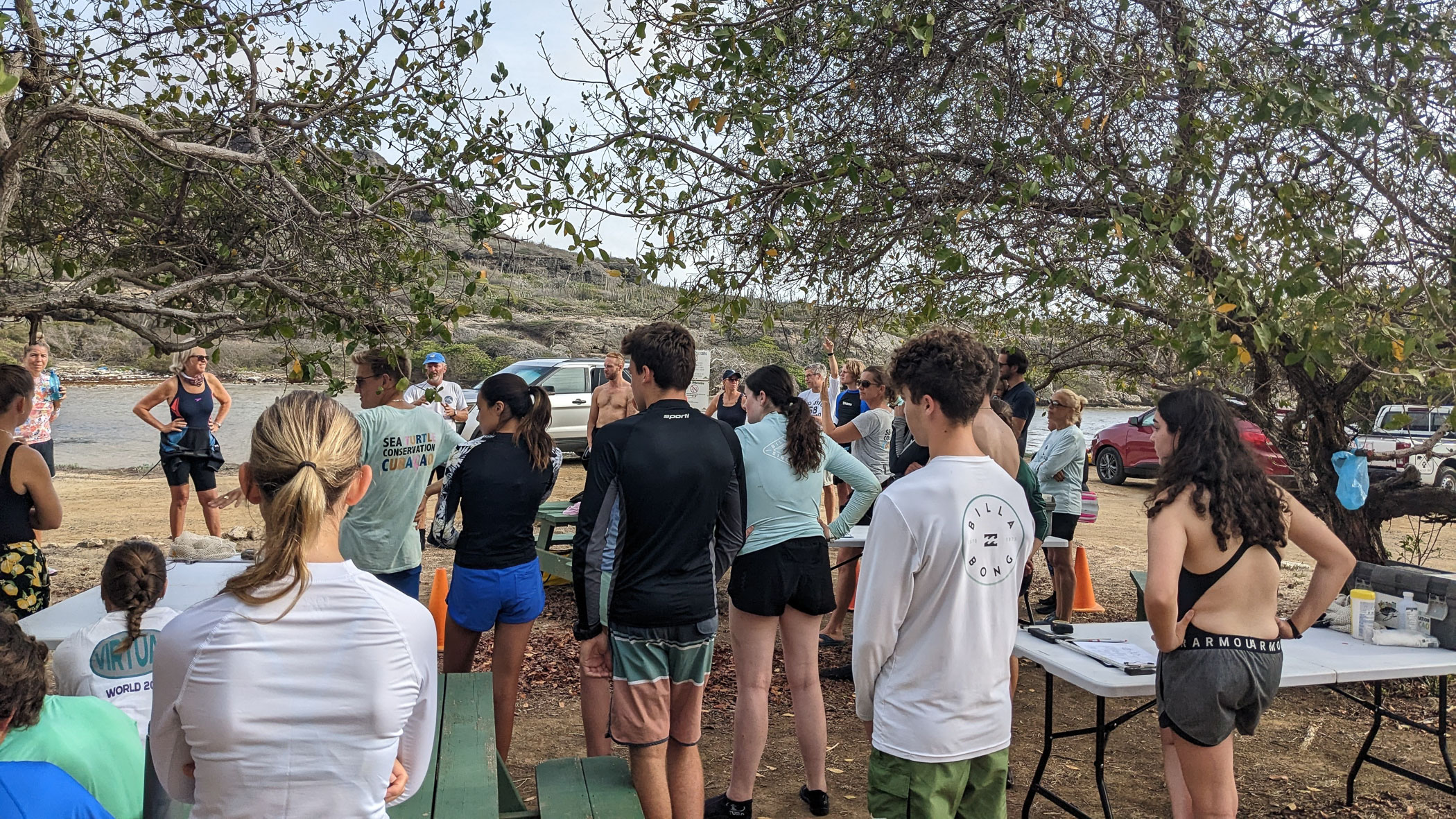 Students at gathering outside below trees